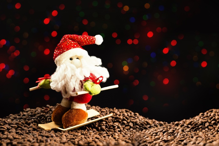 Santa Claus skiing on coffee beans with bokeh lights