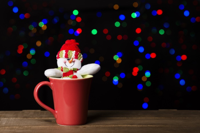 Snowman in a mug with Christmas bokeh