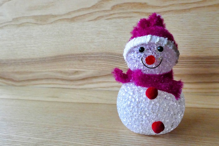 Christmas snowman decoration on wooden background