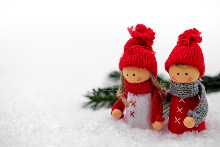 Christmas dolls in snow with pine branch