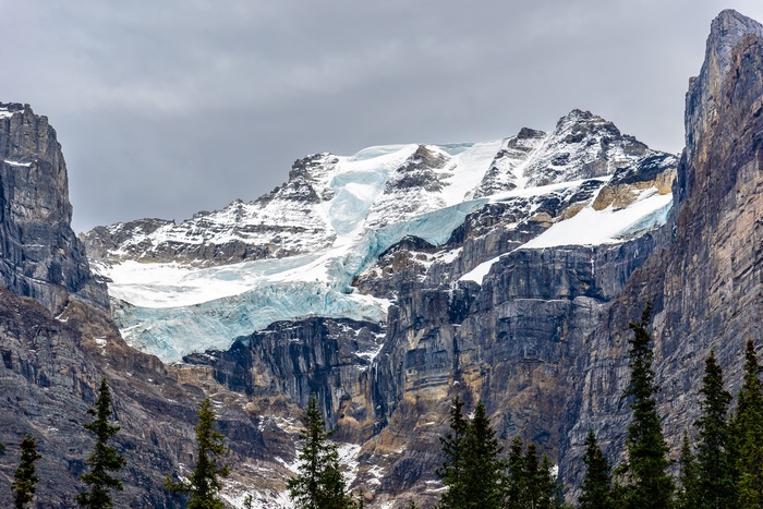 Glacier on a rocky mountain under a cloudy sky
