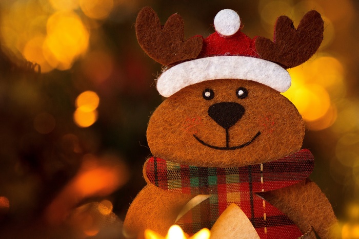 Christmas toy deer with Santa hat and scarf