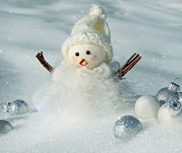 Snowman with Christmas ornaments in snow
