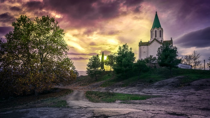 Church with green steeple at sunset