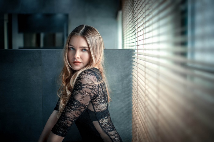 Woman in black lace dress with blonde hair