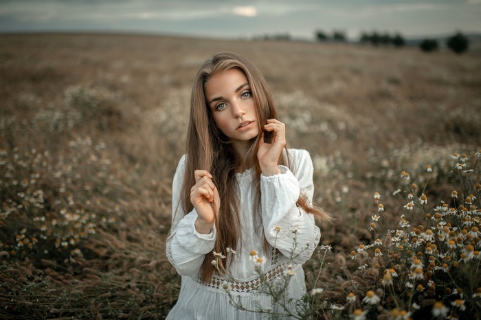 Woman with long brown hair in a field