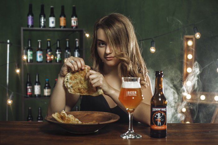 Woman eating food with beer