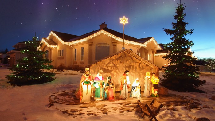 Christmas Nativity scene with house and trees at night