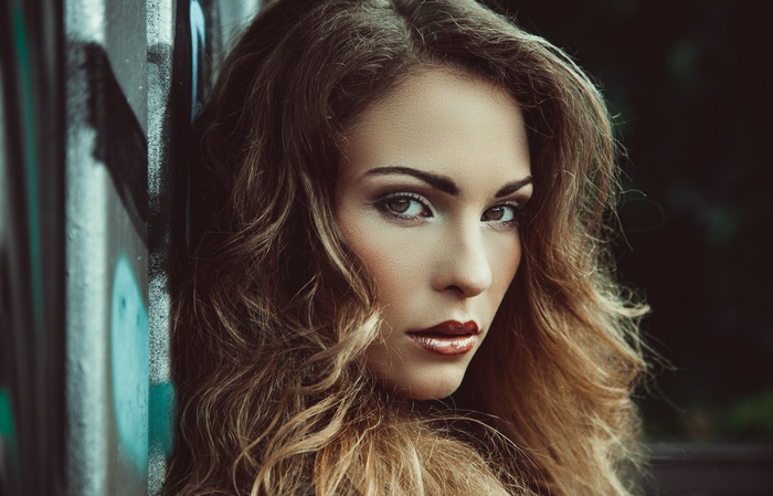 Woman with curly hair and makeup