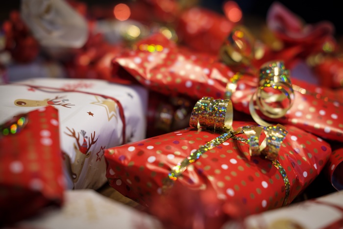 Pile of Christmas Gifts Wrapped in Red and White Paper
