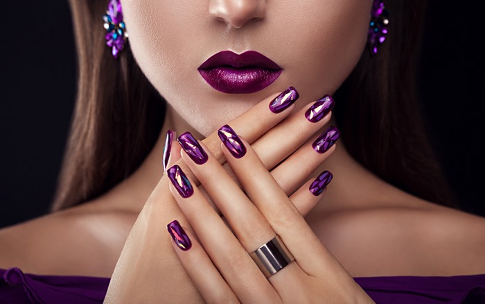 Woman with purple lipstick and nails