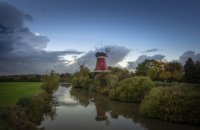 Two windmills by a river in Germany 4K