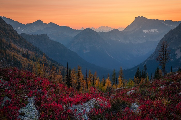 Mountain valley at sunset with autumn foliage