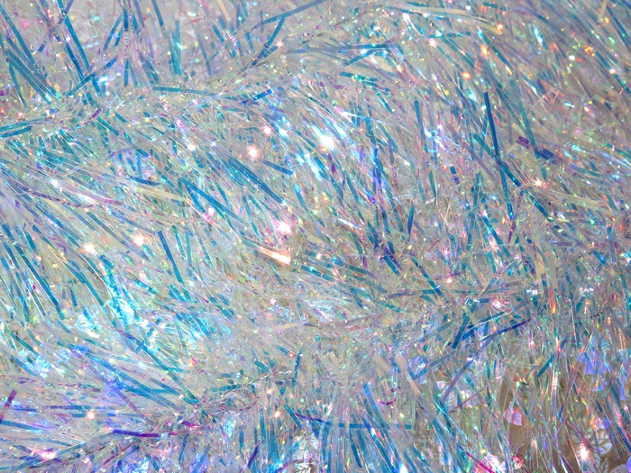 Close-up of iridescent tinsel with blue and purple highlights