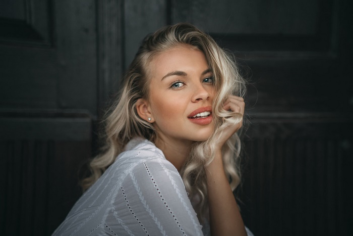 Blonde woman with blue eyes smiling