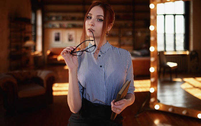 Woman with glasses and book in library
