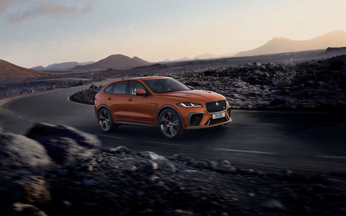 Orange Jaguar F-Pace SVR driving on a winding road