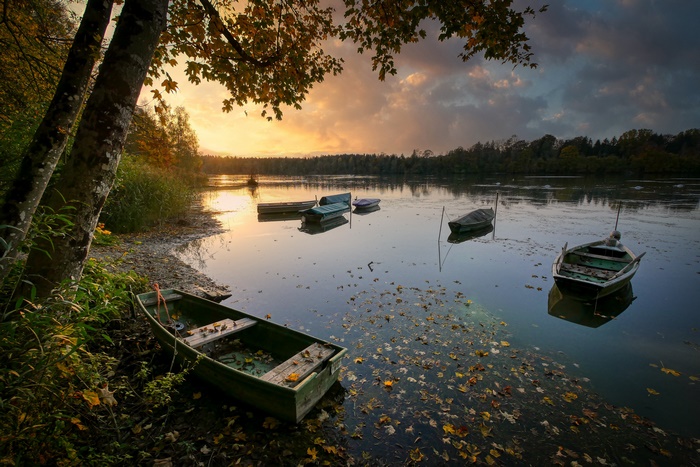 Boats on a lake during fall at sunset
