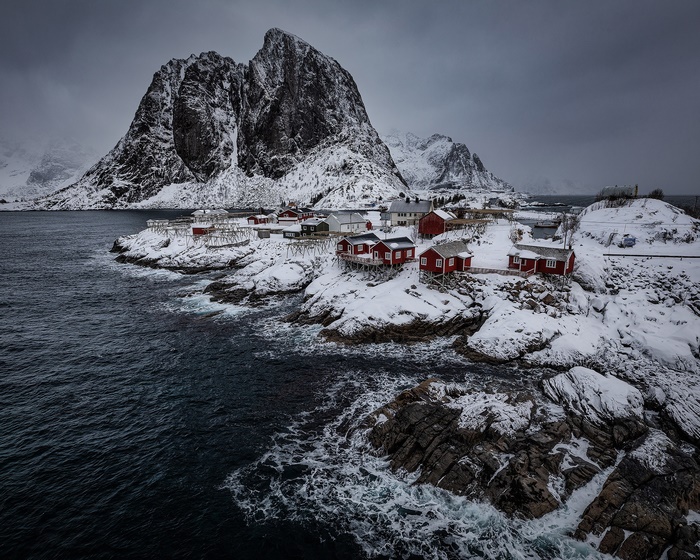 Red houses on a snowy coast in Lofoten, Norway