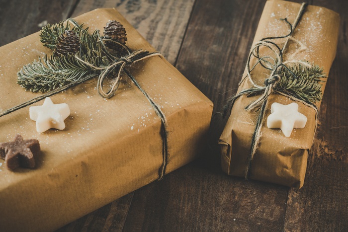 Christmas gifts wrapped in brown paper with pine sprigs