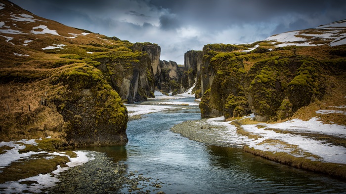 River canyon with snow and mossy rocks