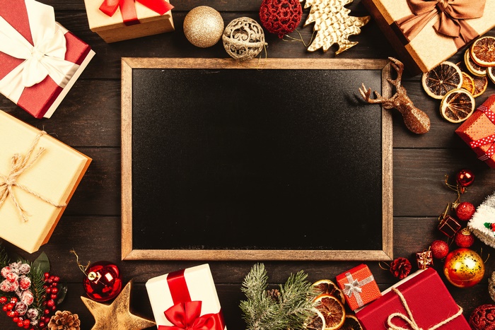 Christmas gifts and ornaments on a blackboard
