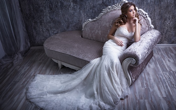 Elegant Bride in White Dress on Sofa