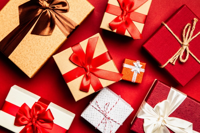 Gift boxes with ribbons on red background 4K