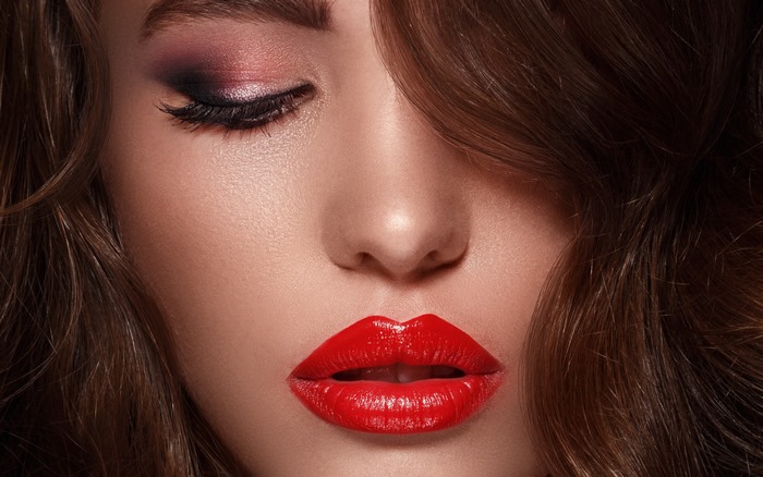 Woman with red lipstick and eye makeup