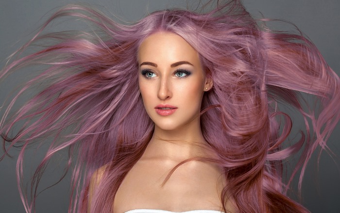 Woman with flowing pink hair and makeup