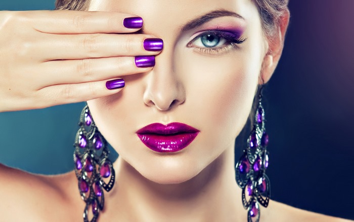Woman with Purple Makeup and Earrings