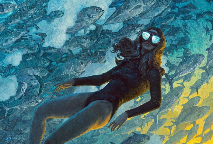 Woman in a swimsuit surrounded by a school of fish