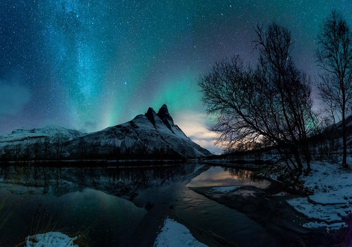 Aurora Borealis over Snowy Mountains and Lake