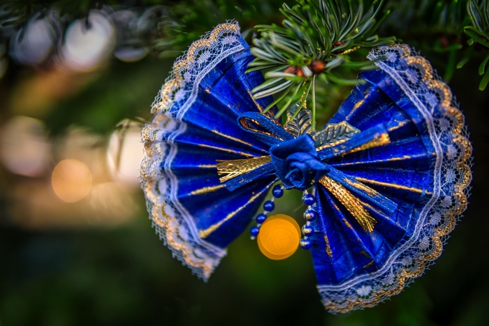 Blue and gold Christmas ornament on a tree