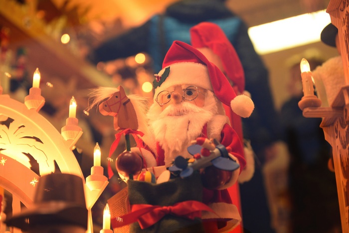 Santa Claus toy with Christmas decorations and candles