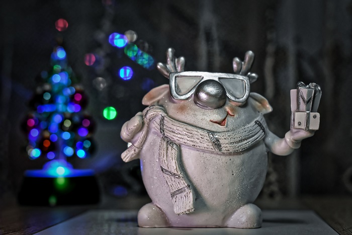 Christmas figurine of a reindeer with sunglasses and scarf