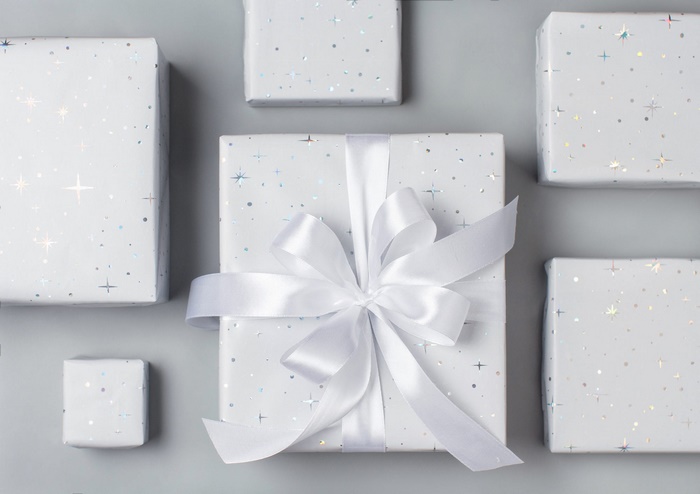 White gift boxes with star pattern and ribbon