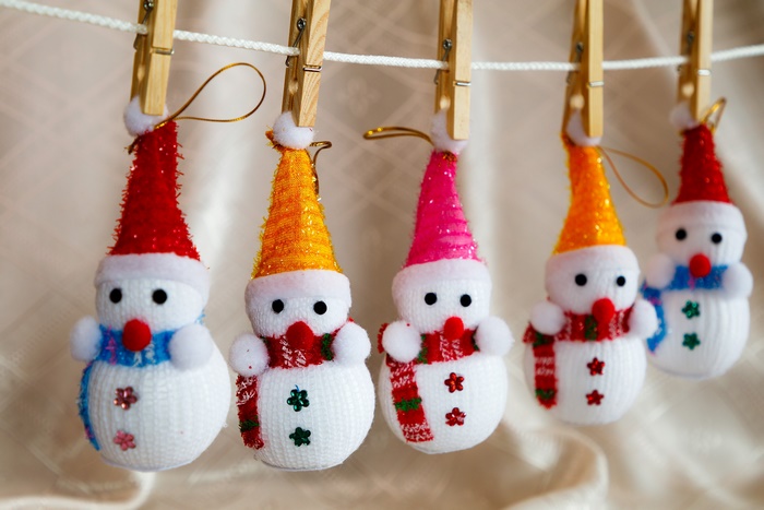 Christmas snowman ornaments hanging on a clothesline