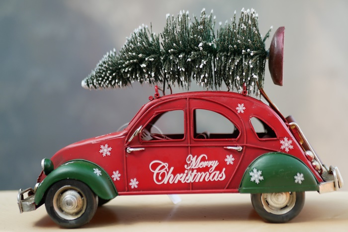 Red toy car with Christmas tree and Merry Christmas text