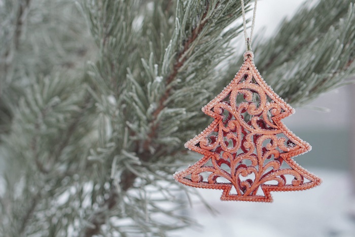Christmas tree ornament on a frosted pine branch