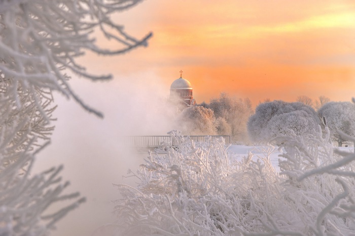 Church dome in winter fog at sunrise