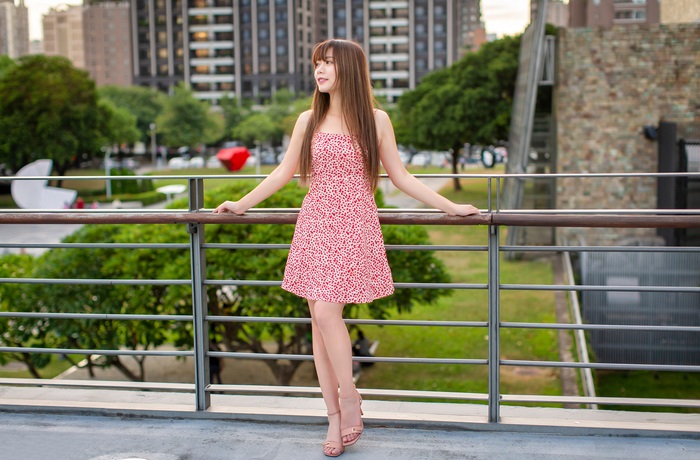 Asian Woman in Red Dress on Balcony
