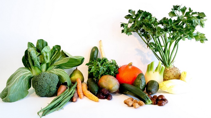 Assortment of fresh vegetables and fruits on a white background