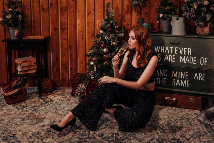 Redhead woman celebrating Christmas with champagne