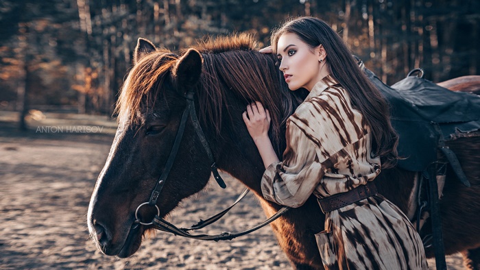 Woman with horse in a forest