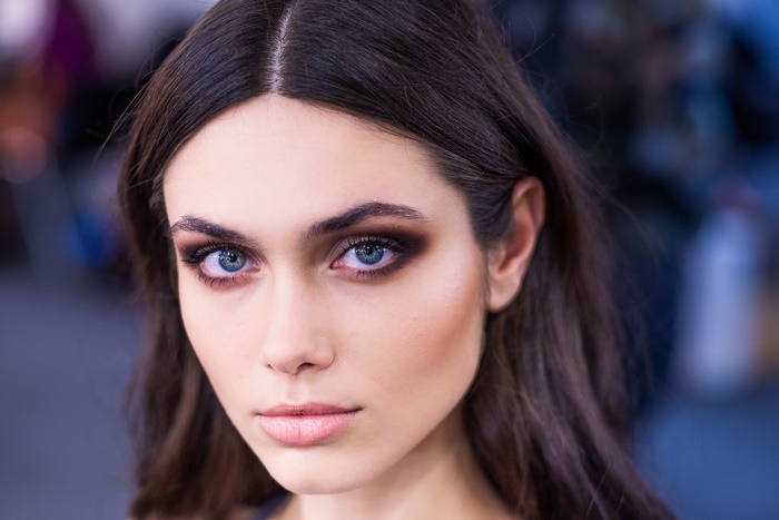 Woman with dark hair and smoky eye makeup