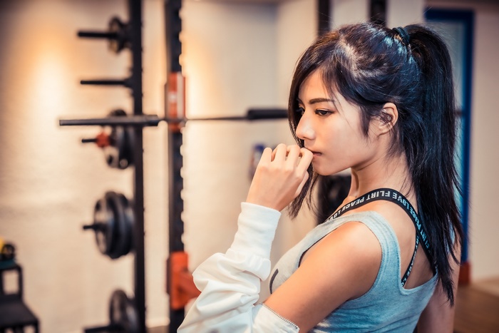 Asian model with ponytail in gym