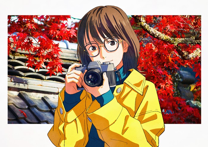 Girl with camera in front of red maple leaves