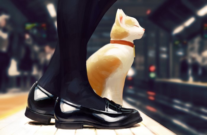 Cat and person on a train platform