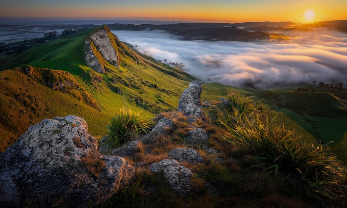 Sunrise over foggy hills in New Zealand
